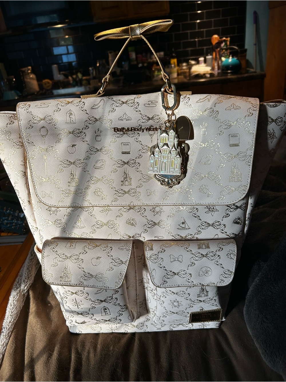 Dooney & Bourke White Patterned Backpack with Gold Charm Accent
